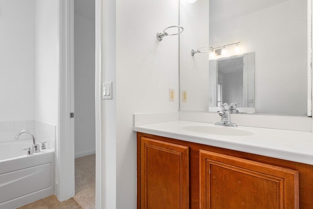 bathroom with tile patterned flooring, vanity, and a tub