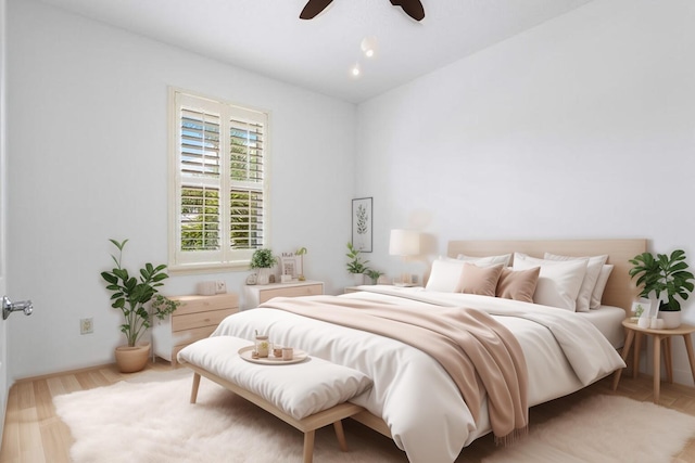 bedroom with light hardwood / wood-style floors and ceiling fan