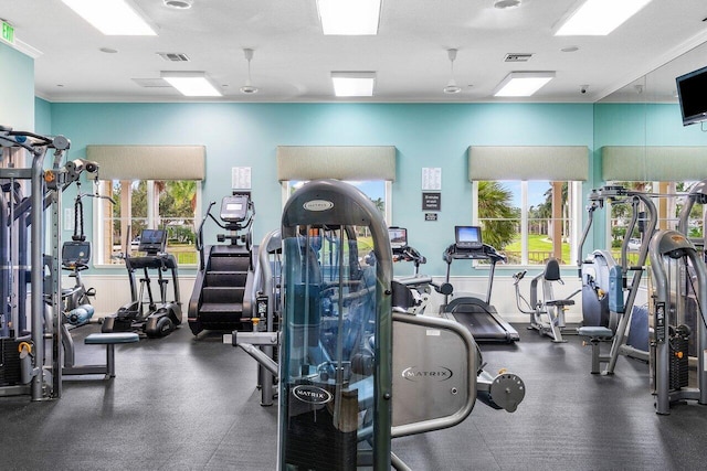 workout area featuring ornamental molding