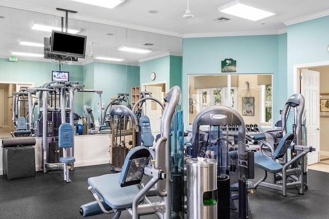 workout area featuring ornamental molding