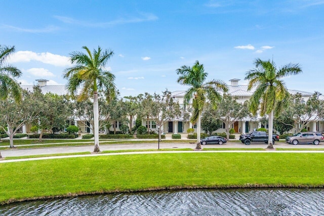 view of home's community featuring a yard and a water view