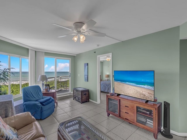 tiled living room with ceiling fan