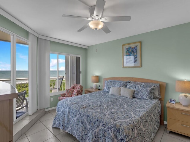 bedroom featuring access to outside, light tile patterned floors, a water view, and ceiling fan