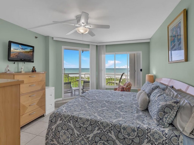 bedroom featuring access to exterior, a water view, light tile patterned floors, and ceiling fan