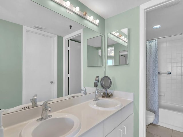 full bathroom with toilet, shower / tub combo with curtain, vanity, and tile patterned flooring