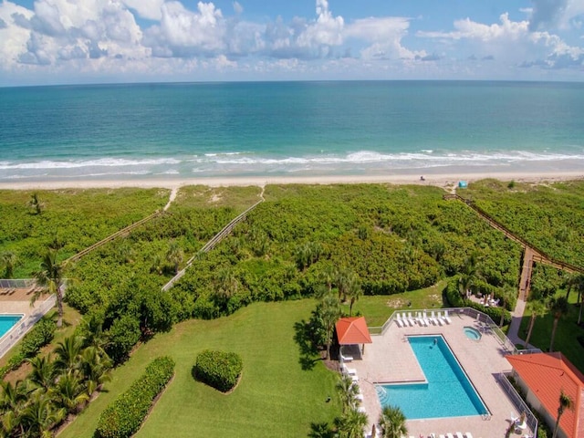 birds eye view of property with a view of the beach and a water view