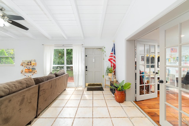 living room featuring french doors, lofted ceiling with beams, light hardwood / wood-style floors, ceiling fan, and wooden ceiling