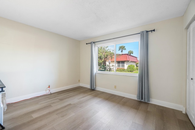 empty room with light hardwood / wood-style flooring