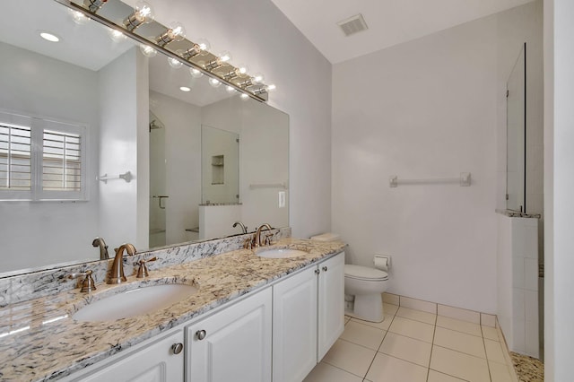 bathroom featuring tile patterned floors, walk in shower, vanity, and toilet