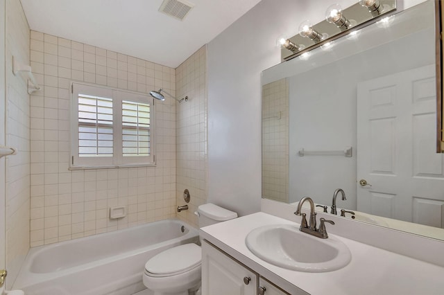 full bathroom featuring vanity, toilet, and tiled shower / bath