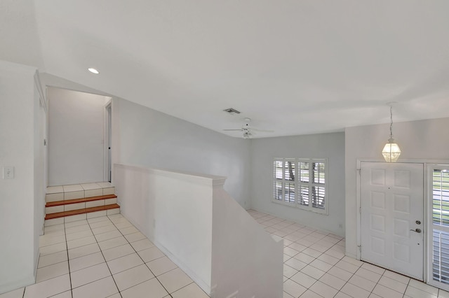 foyer featuring ceiling fan and light tile patterned floors