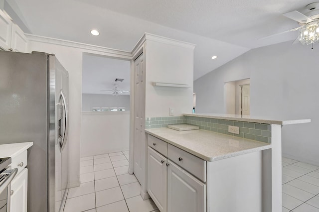 kitchen featuring backsplash, stainless steel fridge, white cabinetry, and kitchen peninsula