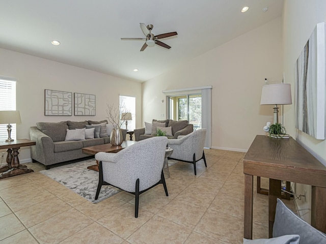 living room with ceiling fan, a healthy amount of sunlight, light tile patterned floors, and vaulted ceiling