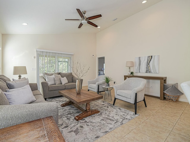 living room featuring high vaulted ceiling, ceiling fan, and light tile patterned flooring