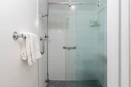 bathroom featuring a shower with door