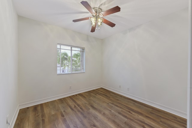 spare room with ceiling fan and dark hardwood / wood-style flooring