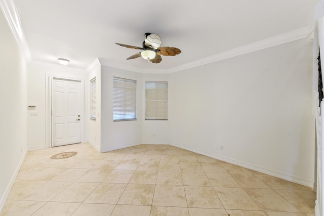 tiled spare room with ornamental molding and ceiling fan