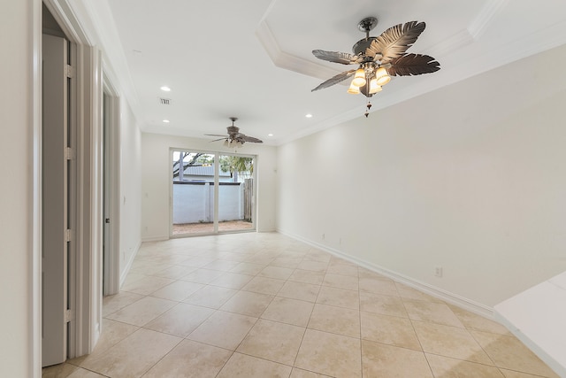 tiled empty room featuring ceiling fan and ornamental molding