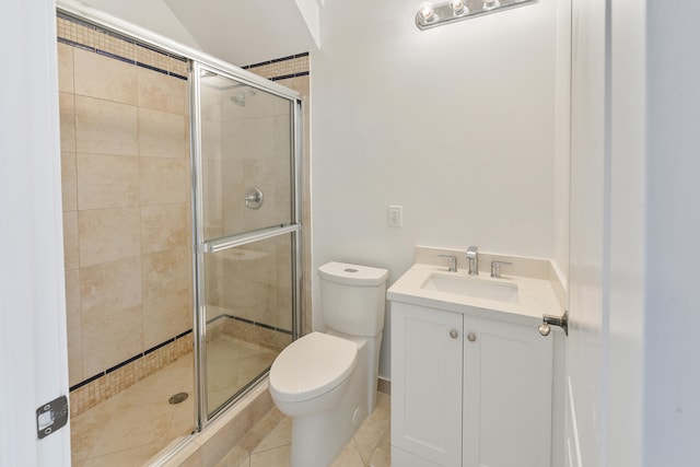 bathroom with toilet, tile patterned flooring, vanity, and a shower with door