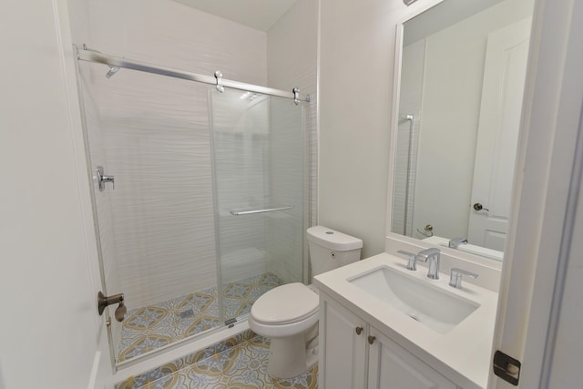 bathroom with a shower with door, vanity, and toilet