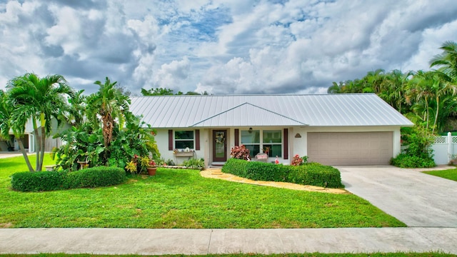 ranch-style house featuring a front yard and a garage