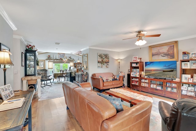 living room featuring crown molding, light hardwood / wood-style floors, and ceiling fan