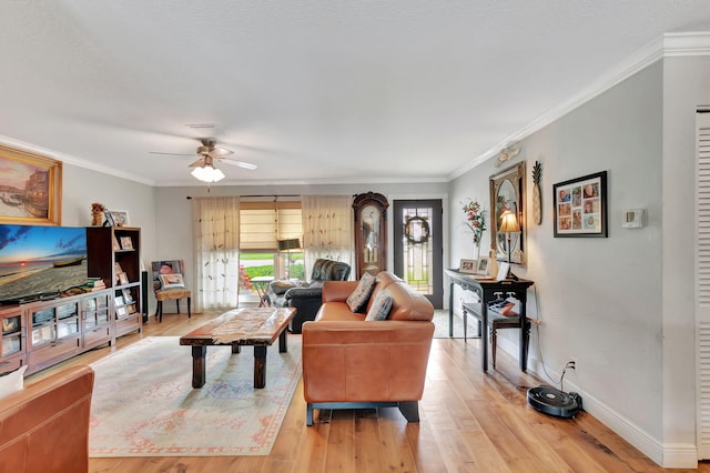 living room featuring light hardwood / wood-style floors, crown molding, and ceiling fan