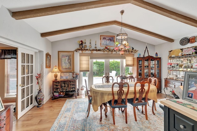 dining room with a chandelier, french doors, light hardwood / wood-style flooring, and lofted ceiling with beams