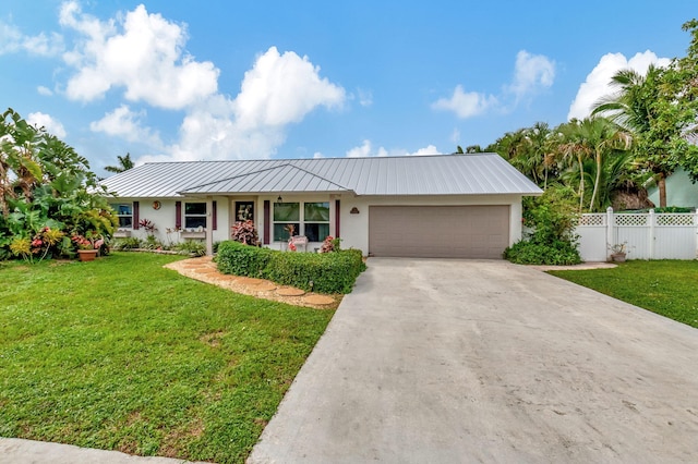 ranch-style home featuring a front yard and a garage