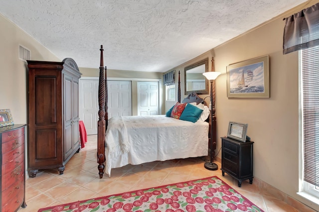 tiled bedroom with a textured ceiling