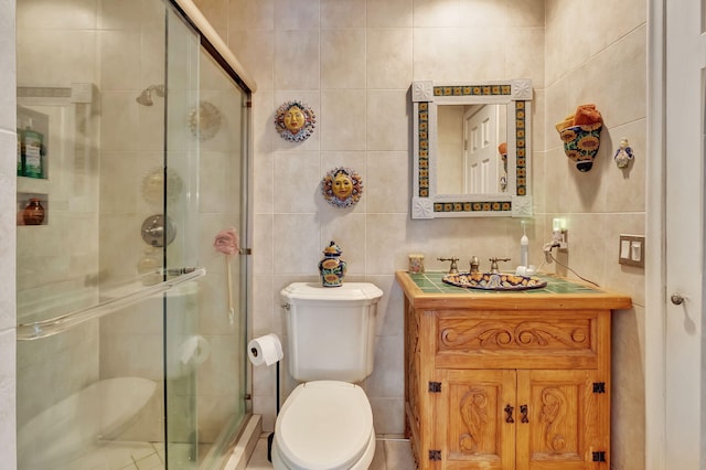 bathroom featuring toilet, an enclosed shower, vanity, and tile walls