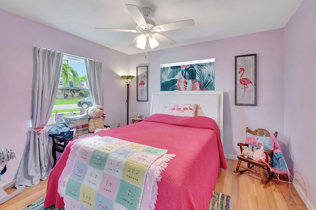 bedroom with wood-type flooring and ceiling fan