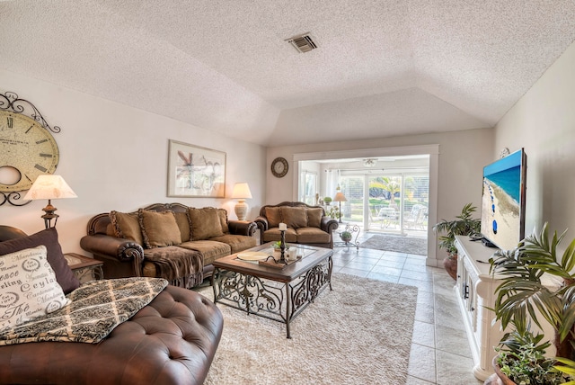 living room featuring light tile patterned flooring, a textured ceiling, and vaulted ceiling