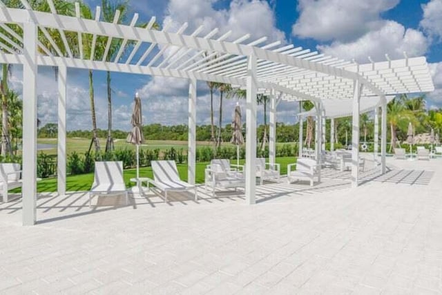 view of home's community with a pergola and a patio