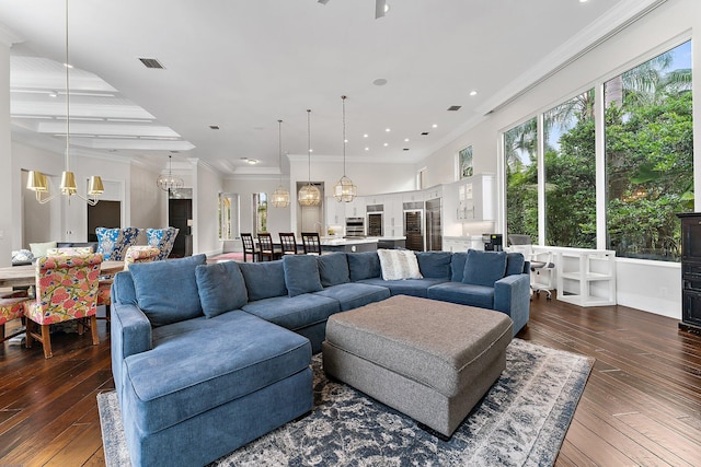 living room featuring ceiling fan with notable chandelier, dark hardwood / wood-style flooring, and crown molding