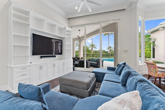 living room featuring hardwood / wood-style flooring, ceiling fan, and crown molding