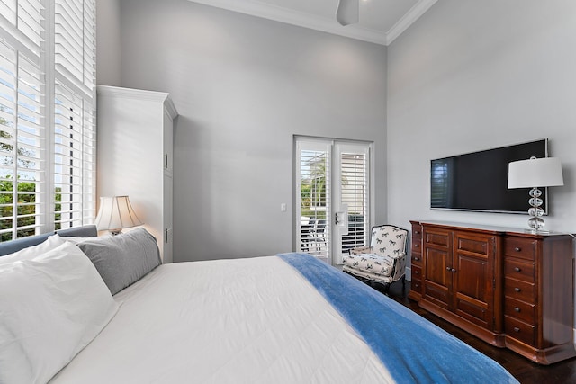 bedroom featuring ceiling fan, dark wood-type flooring, a high ceiling, crown molding, and access to outside