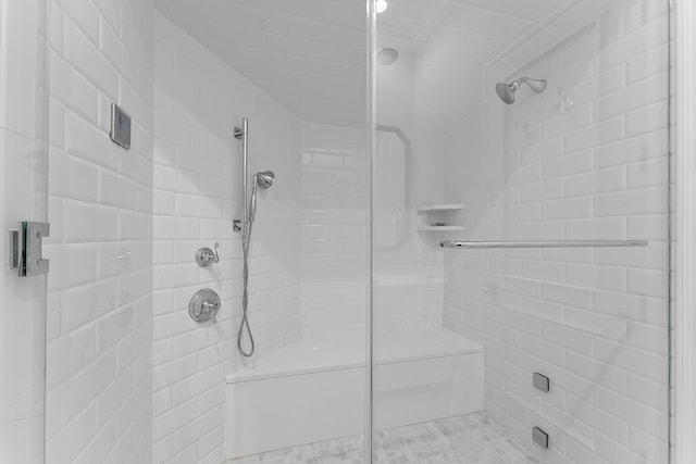 bathroom featuring a shower with door