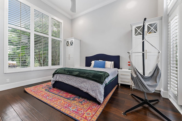 bedroom with ceiling fan, ornamental molding, and dark wood-type flooring