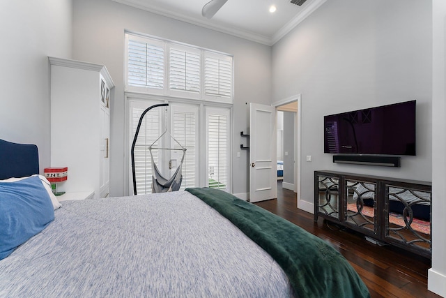 bedroom featuring a high ceiling, dark hardwood / wood-style floors, ceiling fan, and ornamental molding