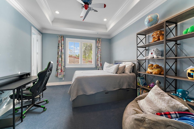 carpeted bedroom with ceiling fan, a raised ceiling, and crown molding