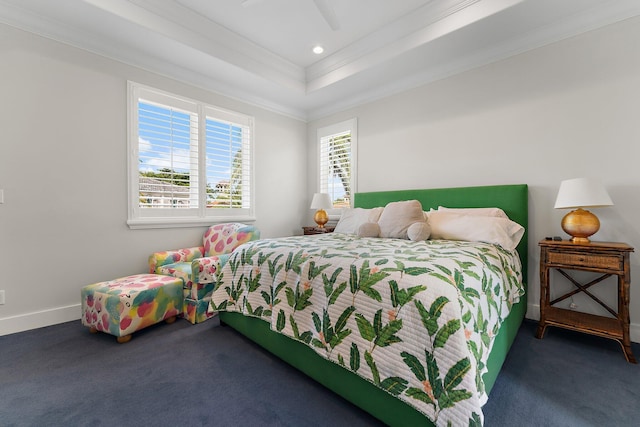 bedroom featuring a raised ceiling, ceiling fan, crown molding, and dark carpet