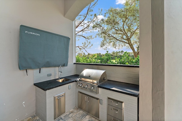 view of patio with an outdoor kitchen, grilling area, and sink