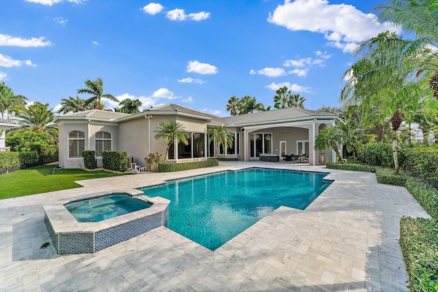 view of pool featuring ceiling fan, a patio area, and an in ground hot tub