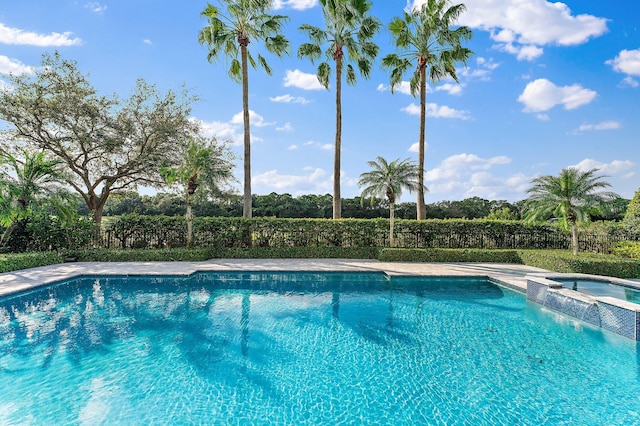 view of pool featuring an in ground hot tub