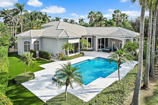 view of pool with a patio area and a yard