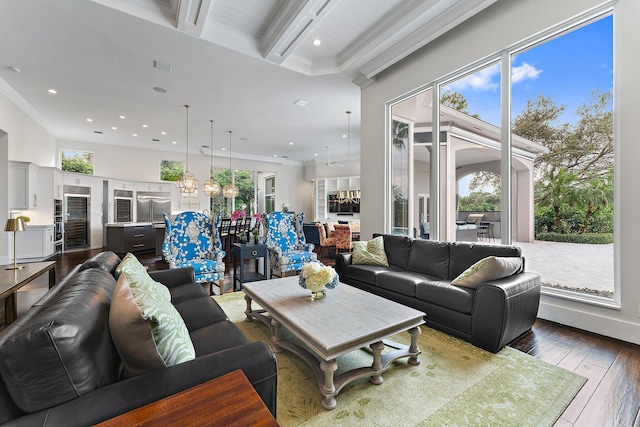 living room featuring ornamental molding, dark wood-type flooring, and a wealth of natural light