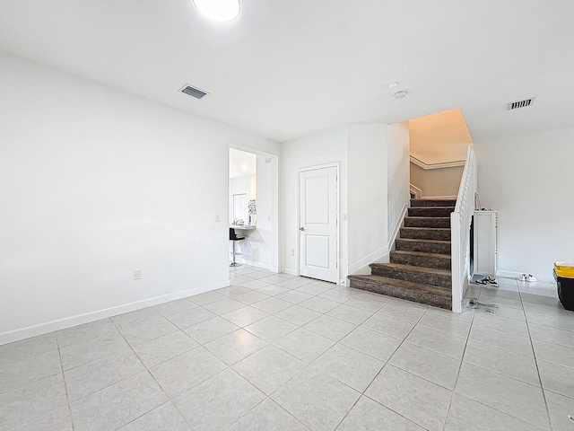 unfurnished room with light tile patterned floors