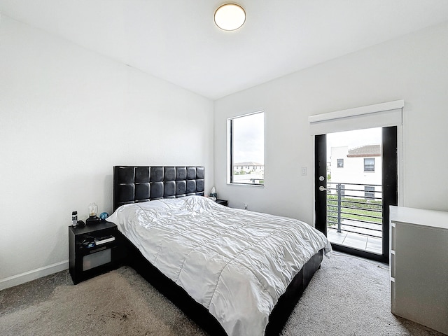 bedroom with access to exterior, carpet flooring, and multiple windows