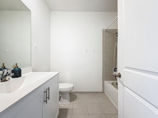 full bathroom featuring toilet, vanity, tiled shower / bath, and tile patterned flooring